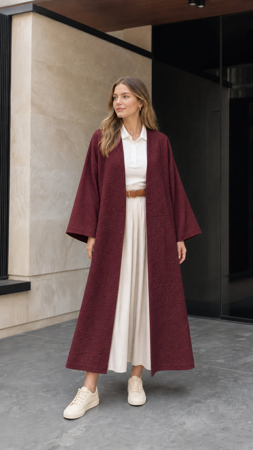 Front view of woman wearing burgundy wine red embossed jacquard maxi duster coat