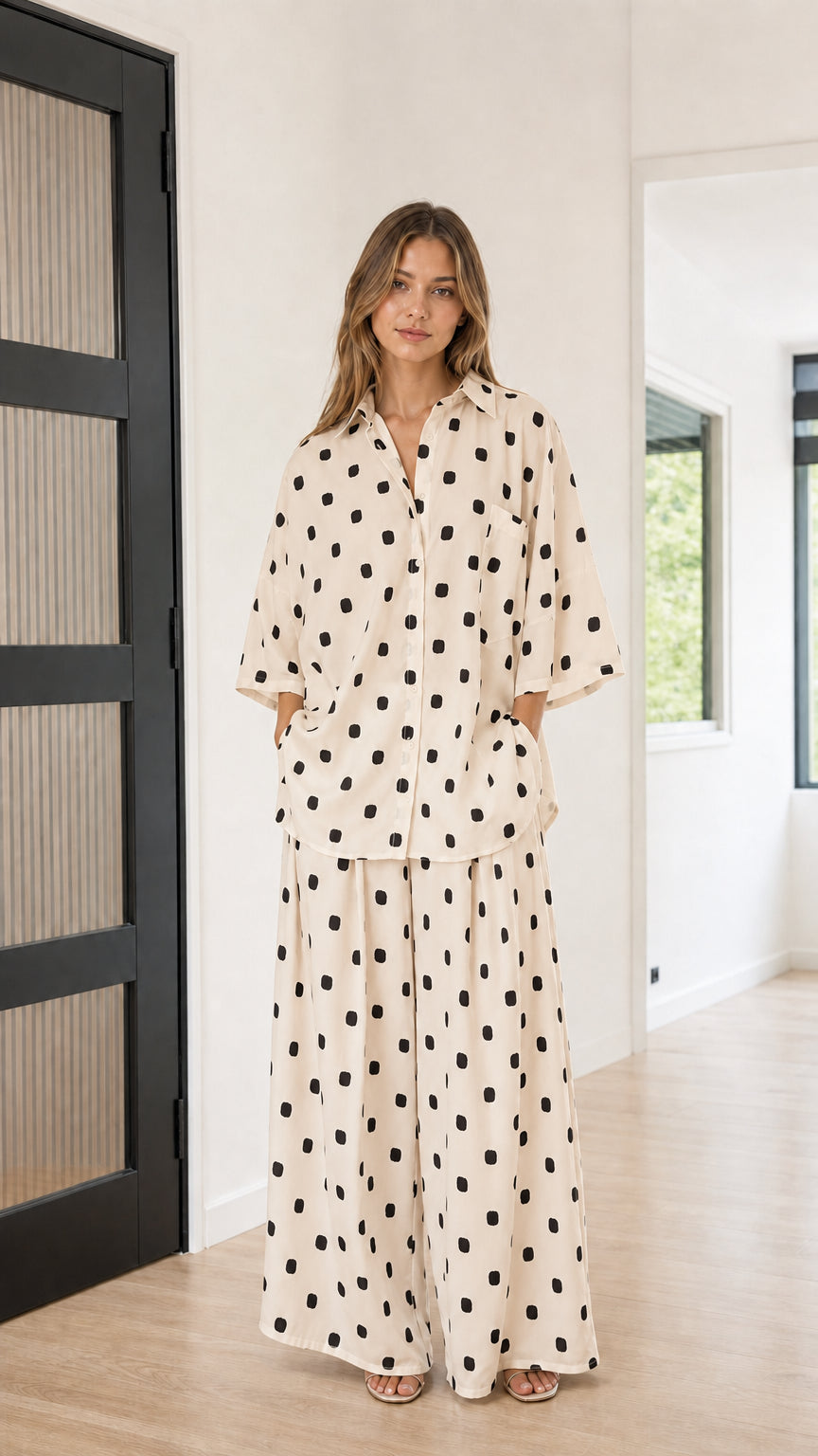 Front view of model wearing beige and black polka dot matching loungewear set