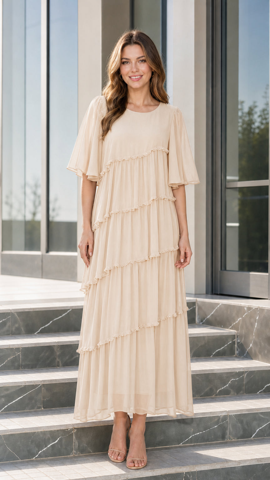 Front view of woman wearing champagne beige tiered chiffon maxi dress