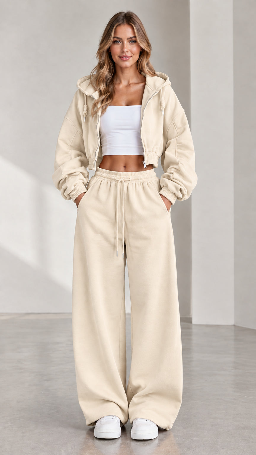 Woman wearing beige cream cropped zip hoodie and matching wide-leg sweatpants set