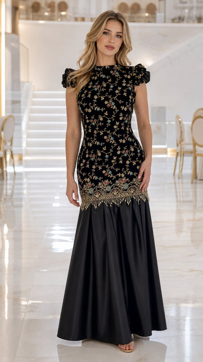 Front view of woman wearing black embroidered velvet mermaid evening gown with beaded fringe