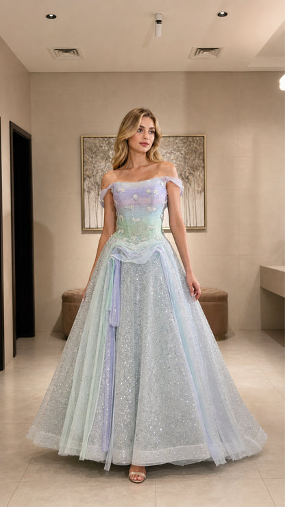 Model wearing pastel ombre glitter tulle ball gown with off-the-shoulder straps and floral bodice, front view