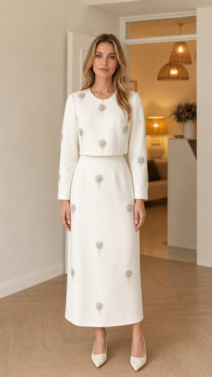 Front view of woman wearing white long sleeve embellished maxi dress