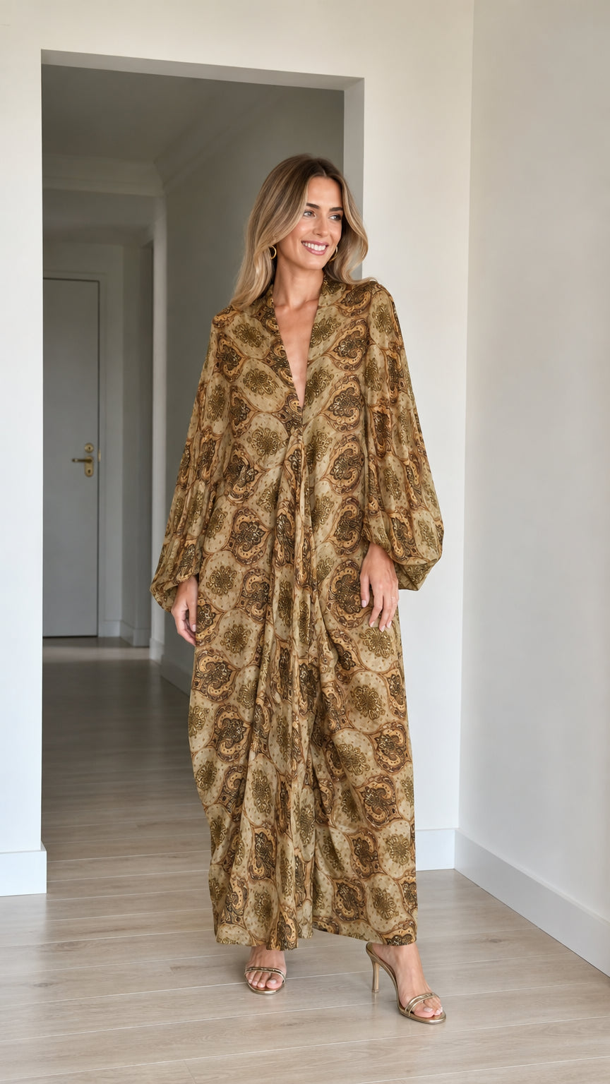 Front full-length view of woman wearing Camel paisley long sleeve maxi kaftan dress with heels