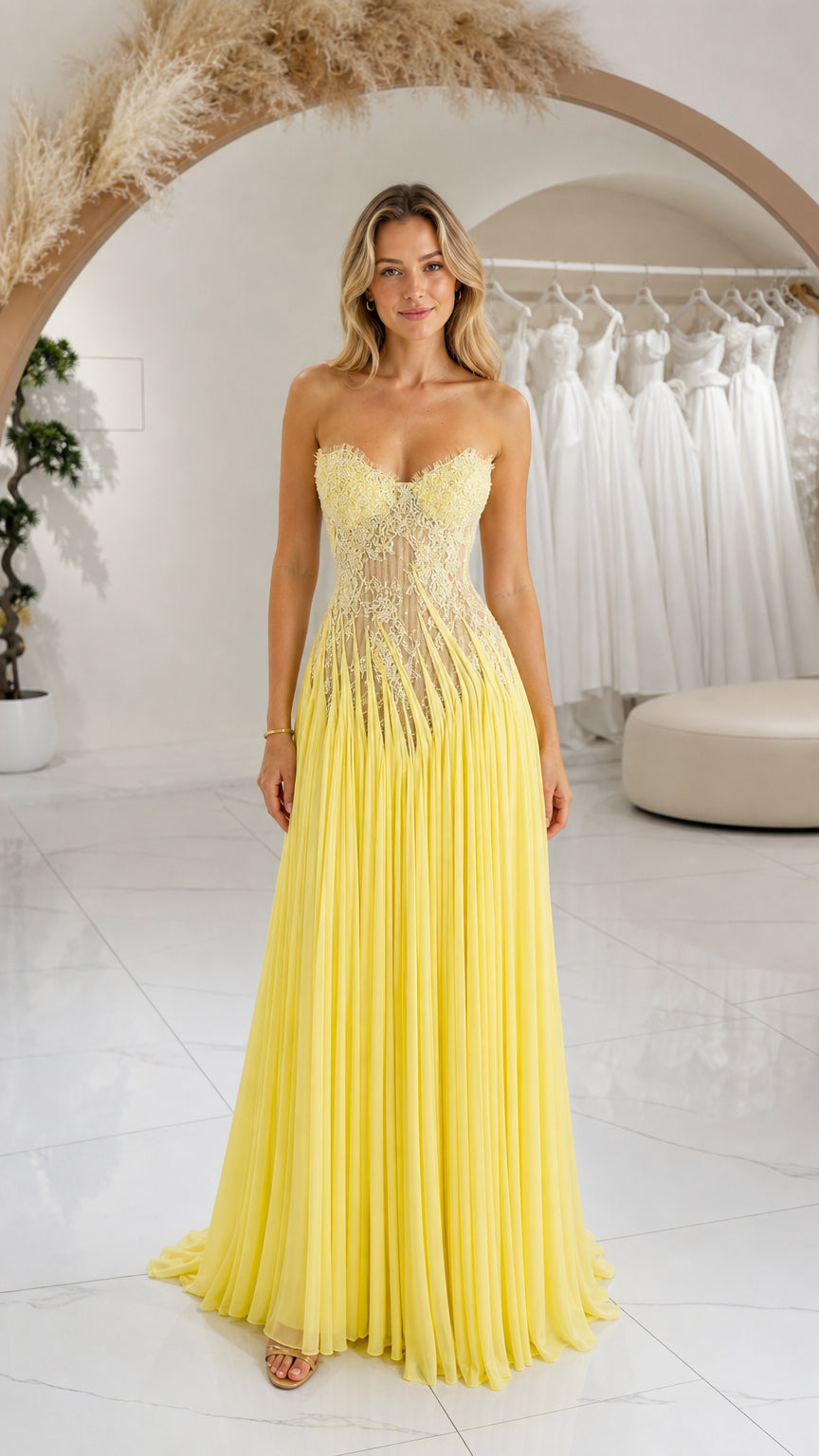 Front full-length view of yellow strapless sweetheart lace and pleated evening gown