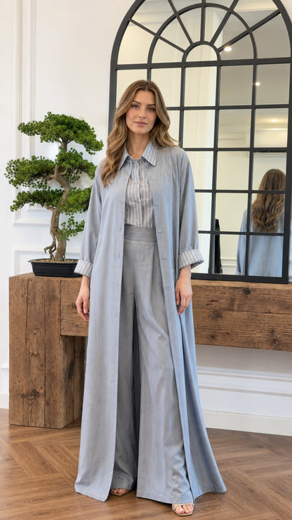 Front view of model wearing the light blue 3-piece modest duster and pant set with striped shirt