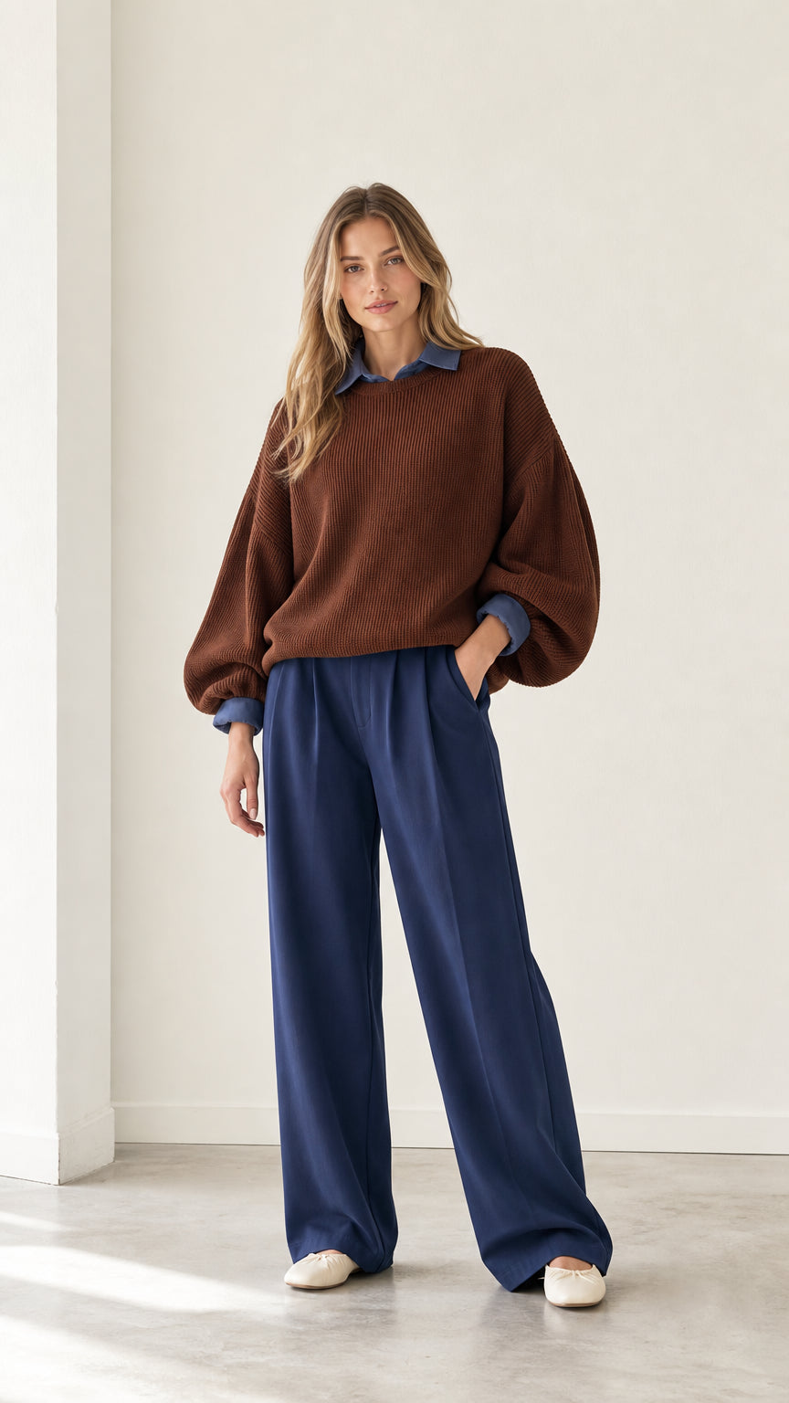 Full front view of model wearing brown 2-in-1 ribbed knit sweater with layered blue shirt collar and wide-leg trousers