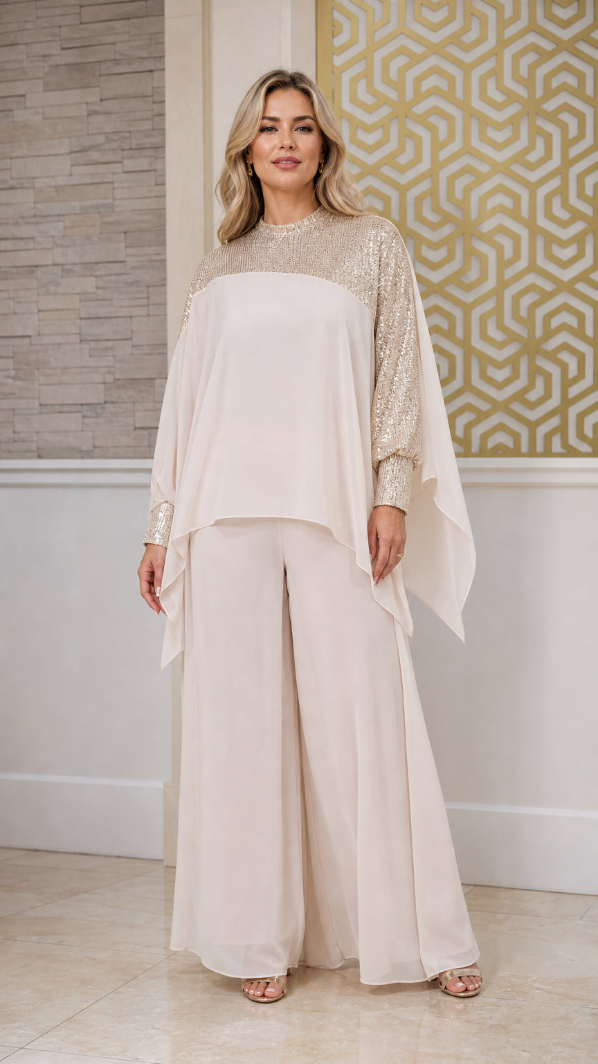 Front view of champagne sequin capelet two-piece evening pant set on model