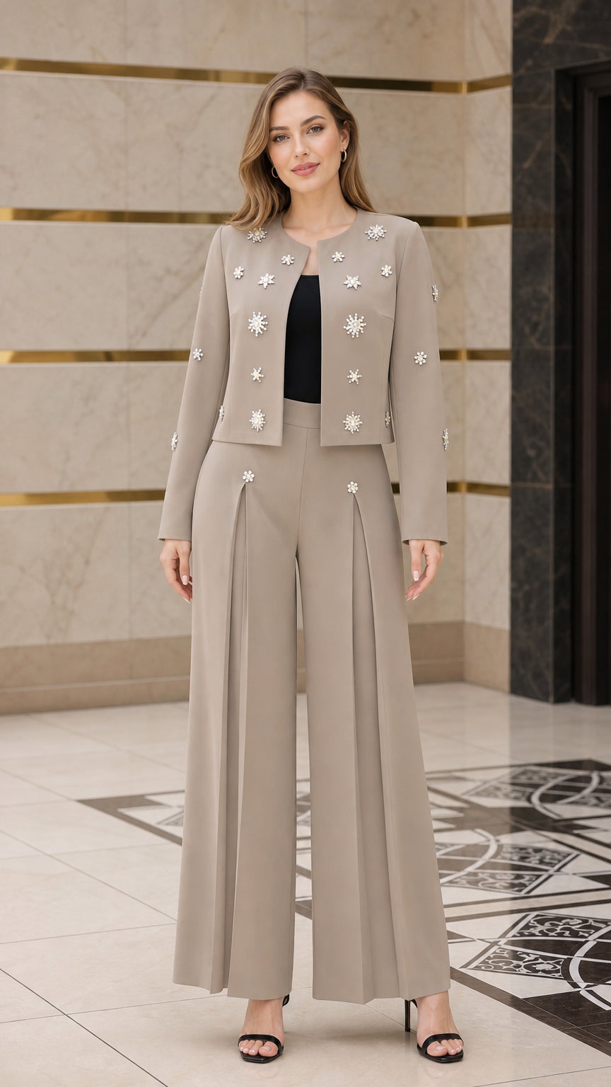 Front view of model wearing taupe embellished cropped jacket and wide-leg pant suit set