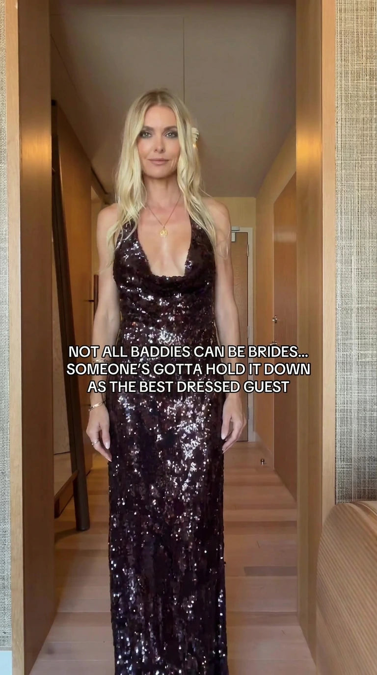 Front view of model wearing burgundy sequin cowl halter maxi evening gown