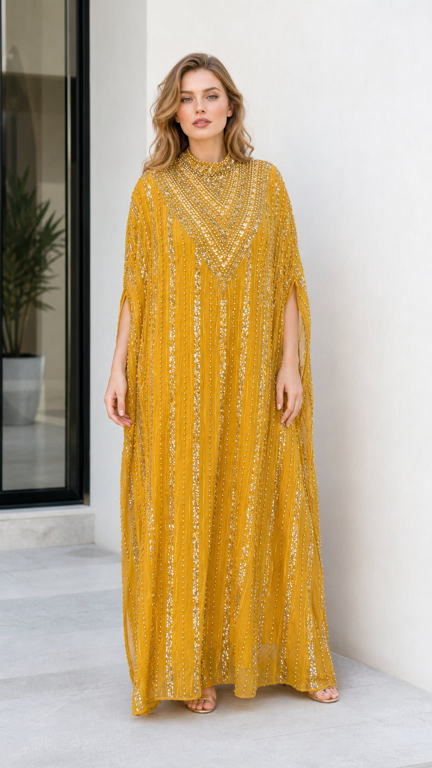 Front view of model wearing mustard yellow sequined cape sleeve kaftan maxi dress