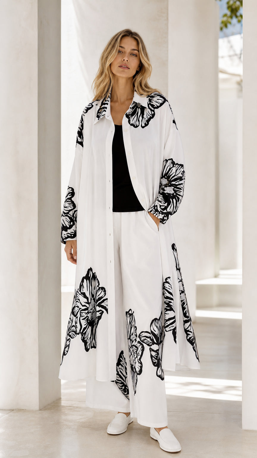 Front full view of women's white longline duster and wide-leg pants set with black floral print