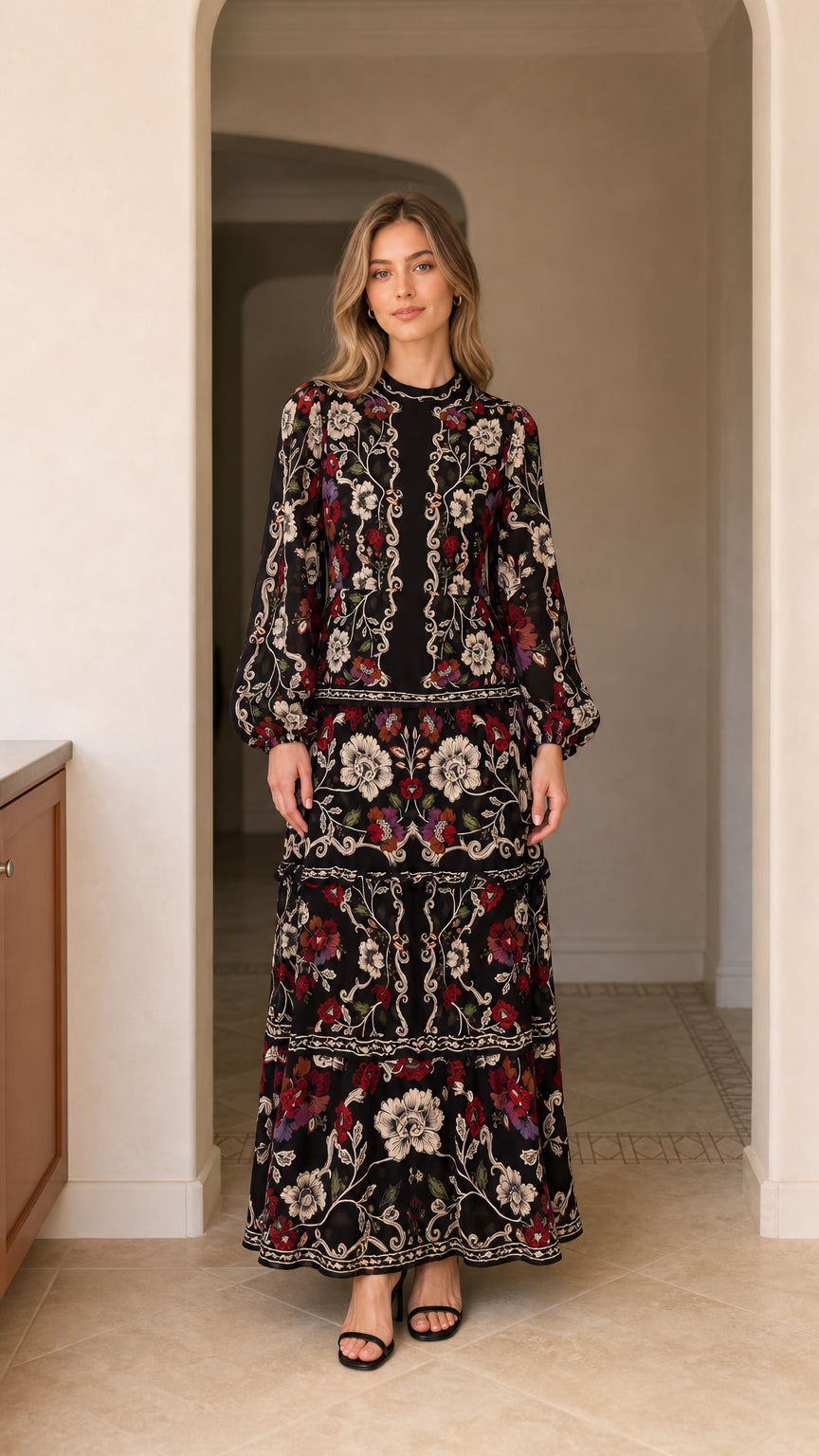 Full front view of model wearing floral print tiered long sleeve maxi dress in black