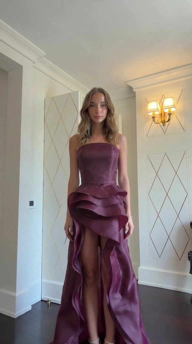 Model wearing Burgundy strapless tiered ruffle evening gown front view