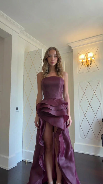 Model wearing Burgundy strapless tiered ruffle evening gown front view