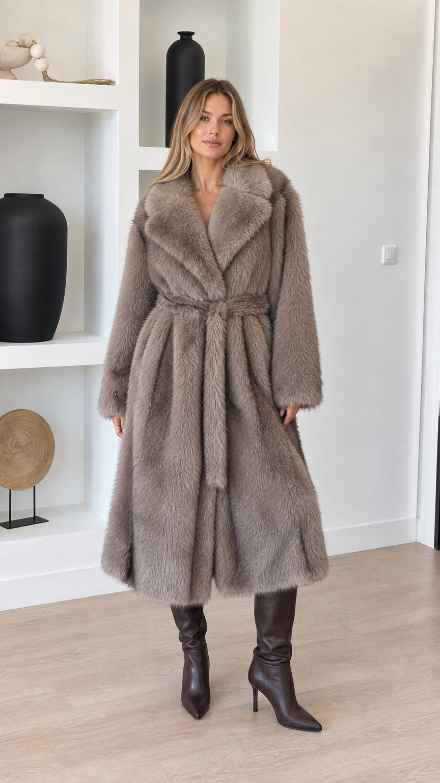 Front full-length view of model wearing taupe plush faux fur belted long coat with tall brown boots