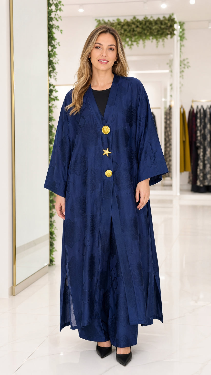 Front full-length view of woman wearing navy blue textured jacquard maxi abaya with gold buttons