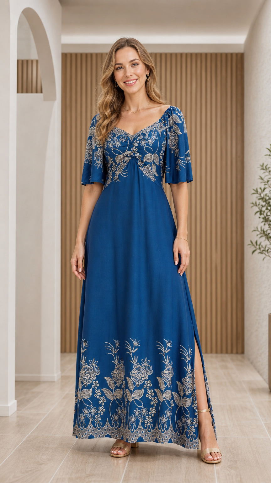 Front full view of woman wearing Royal Blue floral embroidered sweetheart maxi dress with flutter sleeves