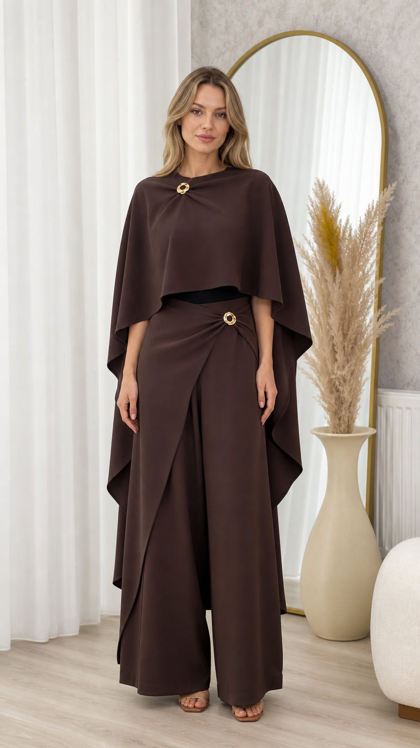 Full front view of model wearing chocolate brown draped cape top and matching wide-leg trousers set