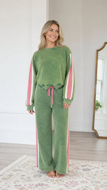 Front view of model wearing the Sage Green vintage washed sweatshirt and wide-leg sweatpants set with pink side stripes