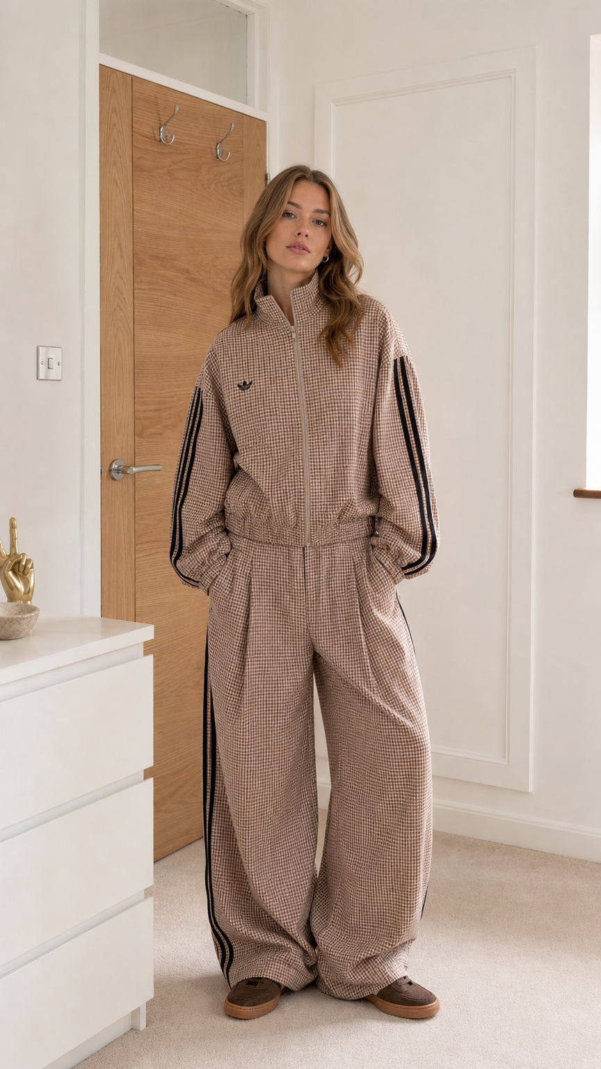 Taupe gingham women's jumpsuit shown from the front with high collar and contrast side stripes