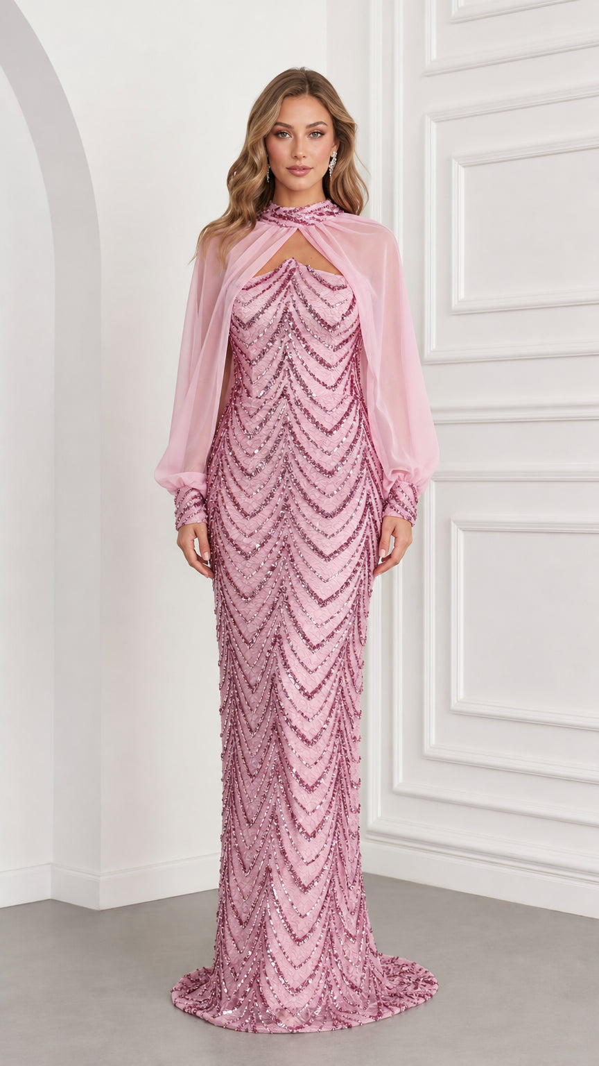 Front view of woman wearing pink sequin column evening gown with sheer chiffon cape overlay