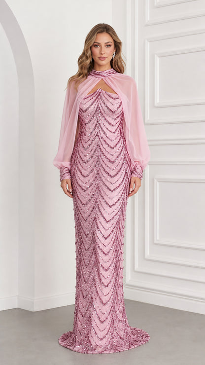 Front view of woman wearing pink sequin column evening gown with sheer chiffon cape overlay