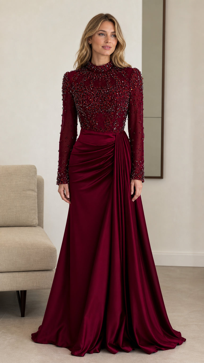 Front view of model wearing burgundy long sleeve beaded high neck evening gown with draped satin skirt