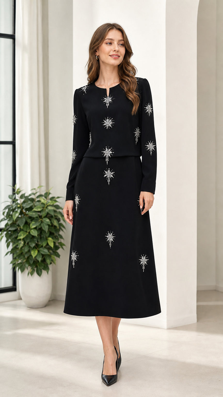 Front full view of woman wearing black long sleeve rhinestone embellished midi dress