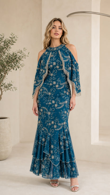 Front view of model wearing Teal Blue beaded cold-shoulder capelet maxi evening gown