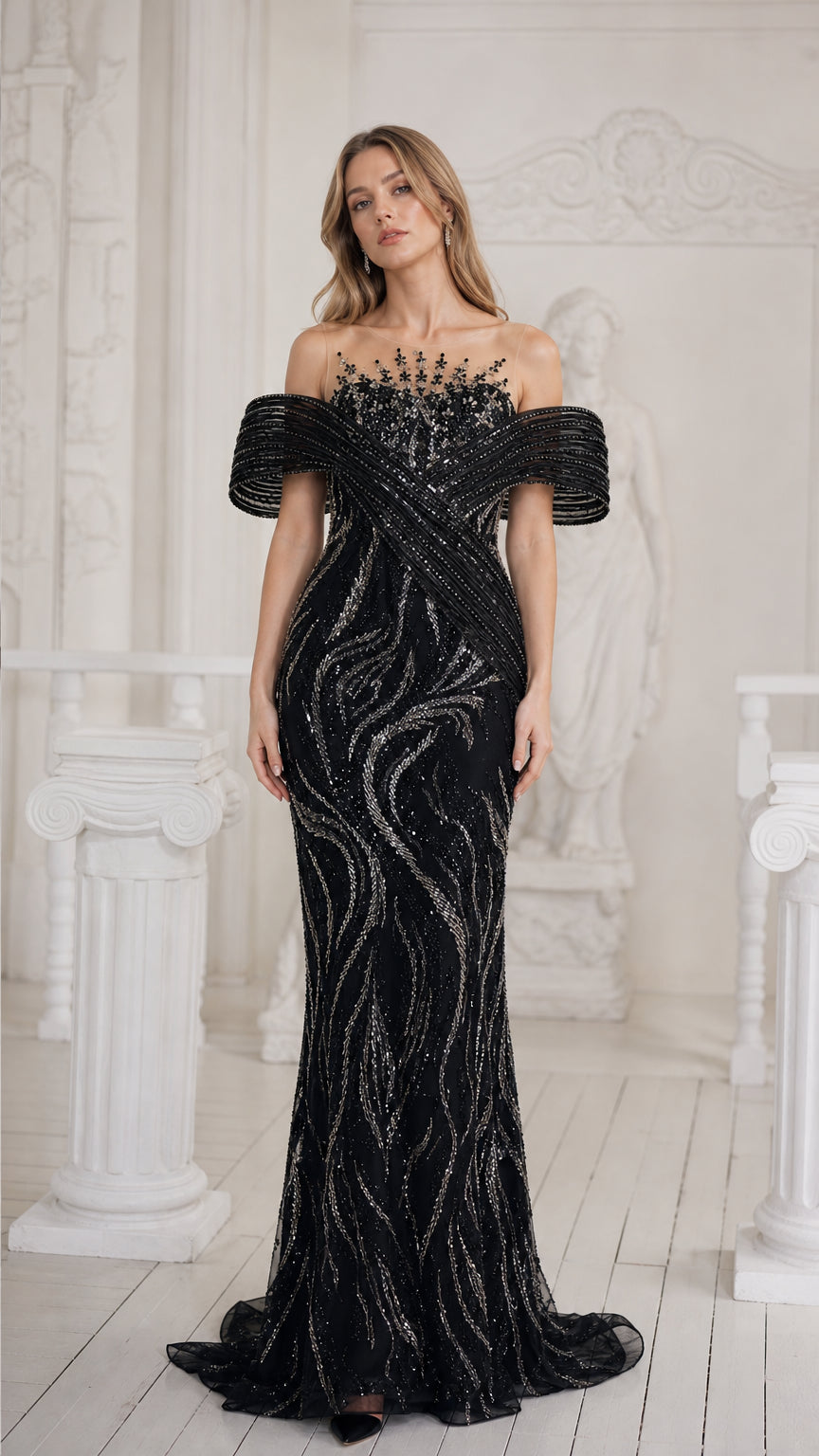 Front view of black sequined illusion mermaid evening gown with draped off-the-shoulder sleeves