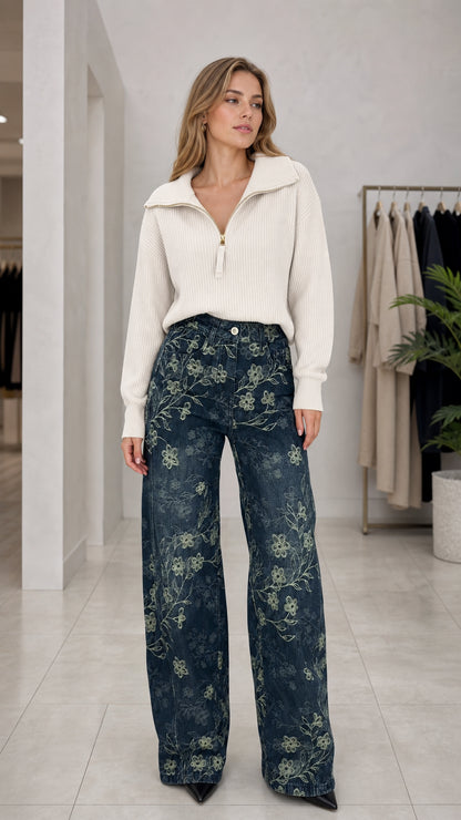 Front full view of woman wearing Denim Blue floral embroidered wide leg pants and white knit sweater