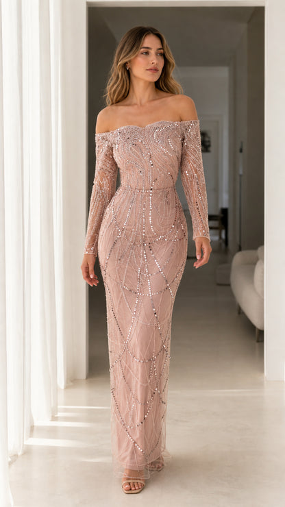 Front view of woman wearing dusty rose off-the-shoulder long sleeve sequin maxi evening gown