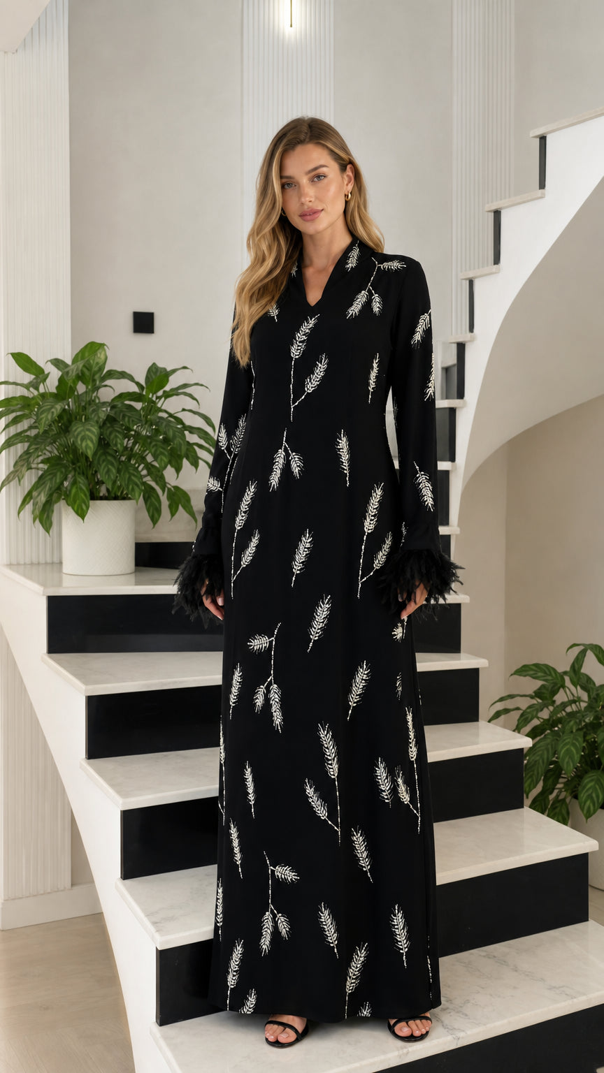 Front view of black embroidered maxi dress with feather cuffs