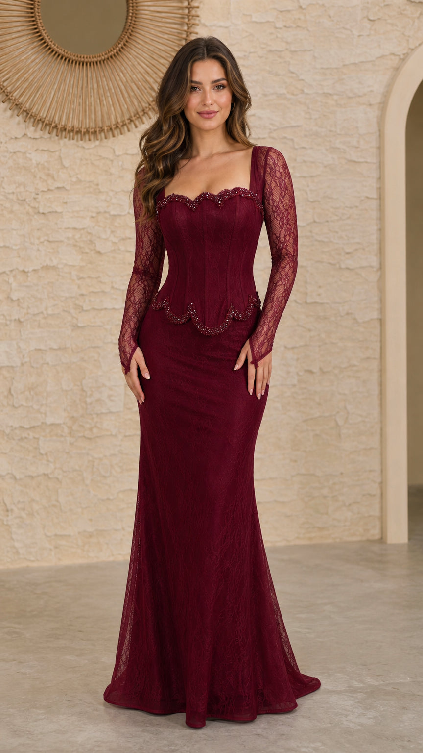 Front view of burgundy long sleeve lace evening gown with beaded corset bodice