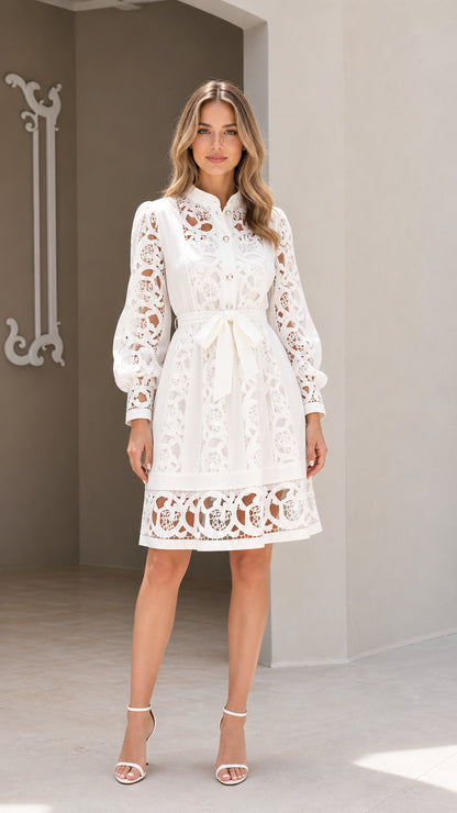 Model wearing white long sleeve embroidered lace belted shirt dress front view