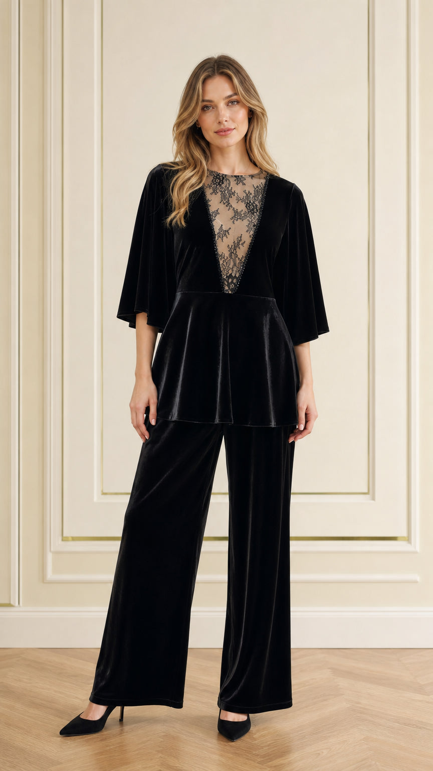 Front view of woman wearing black velvet two-piece pant set with sheer lace insert
