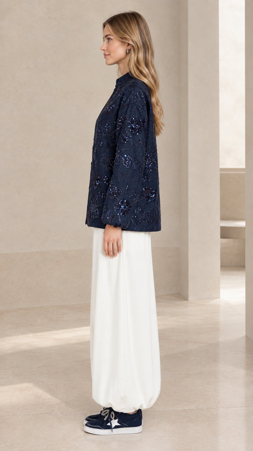 Side profile view of navy blue sequin embroidered long sleeve jacket blouse