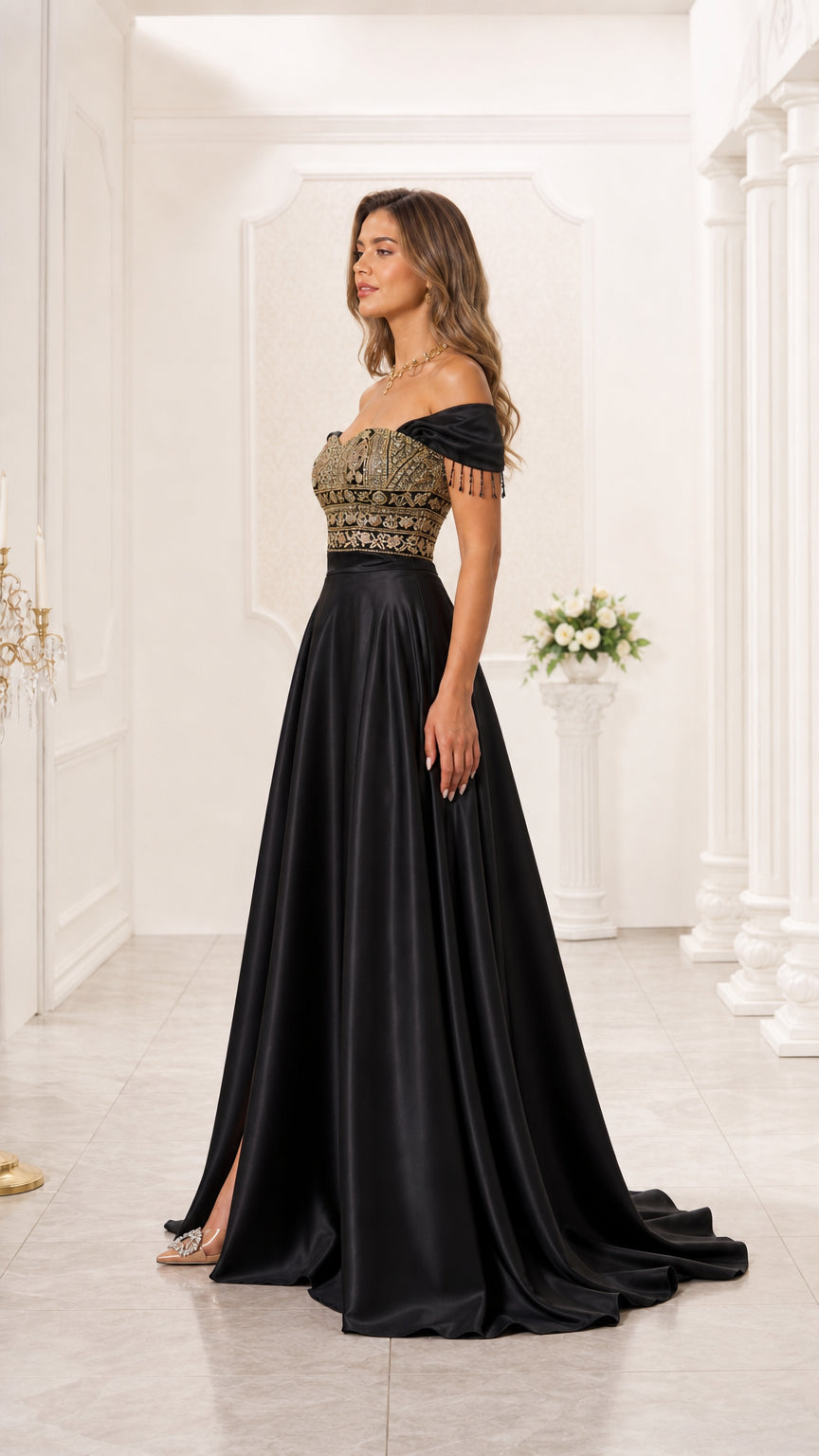 Side angle of model in black off-the-shoulder embroidered evening gown with side leg slit