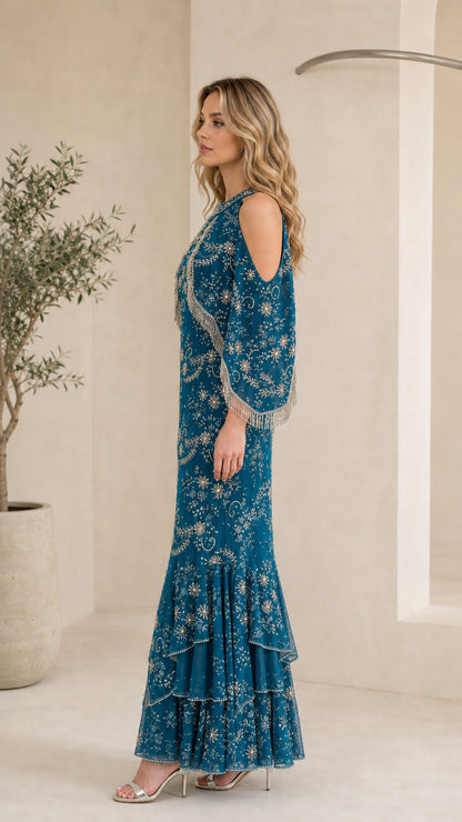 Side profile of model in Teal Blue beaded fringe capelet gown showing silhouette