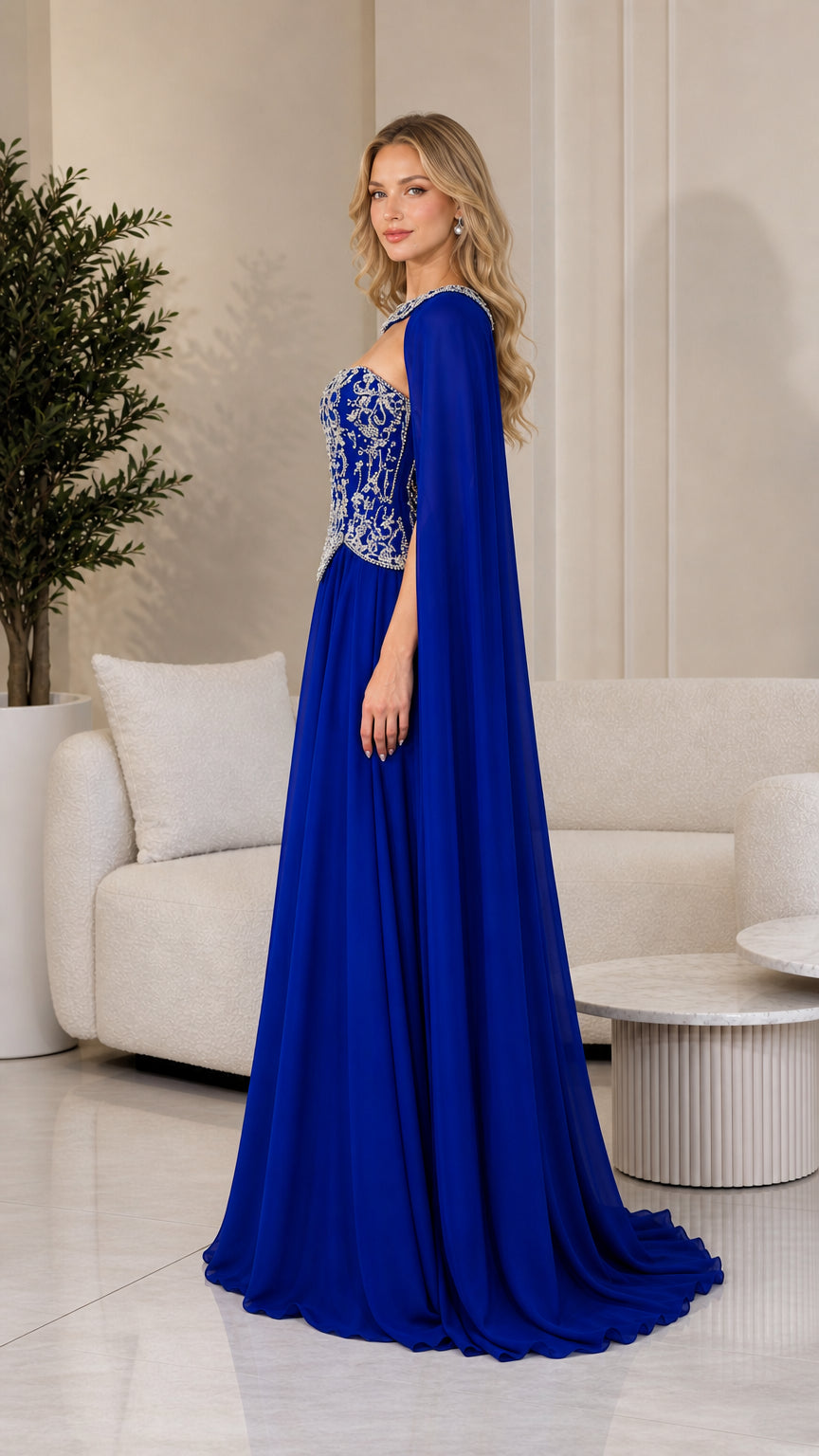 Side profile of royal blue cape evening dress showing flowing silhouette