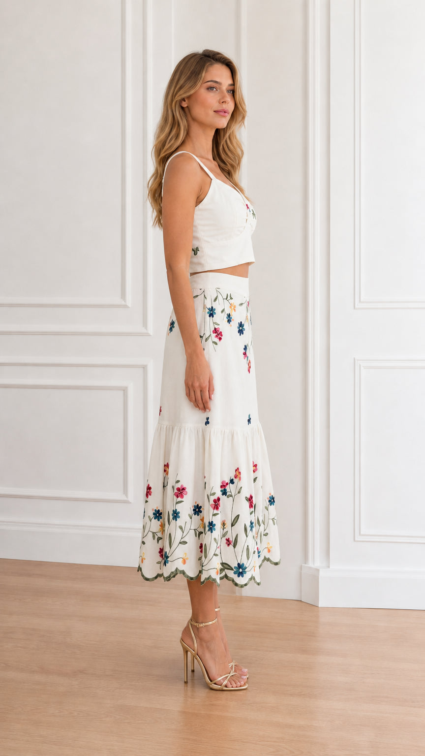 Side angle view of model wearing white floral embroidered two-piece set