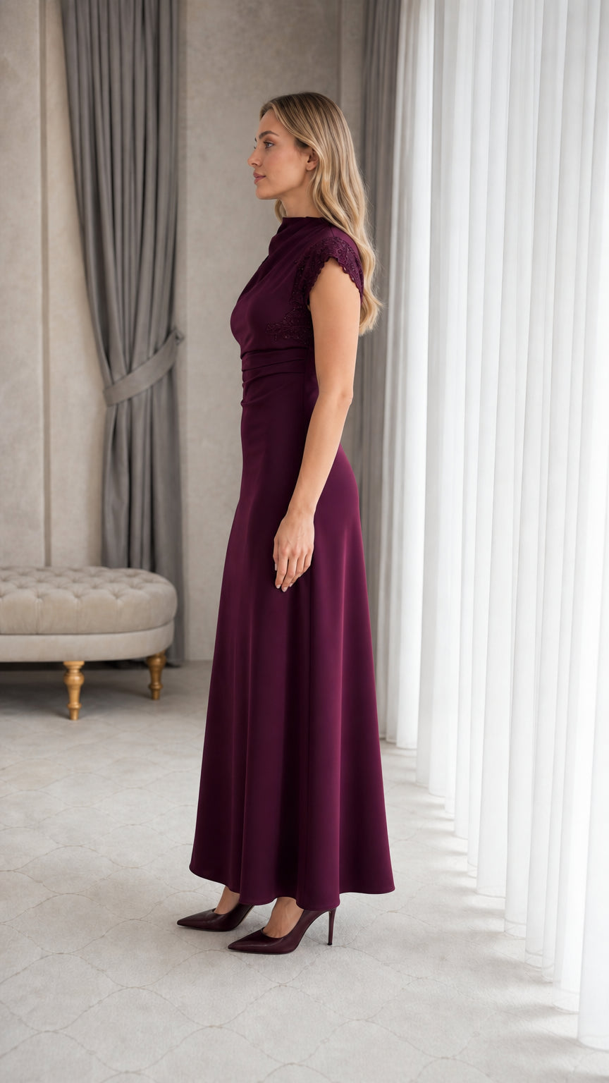 Side profile view of woman wearing plum formal evening maxi gown