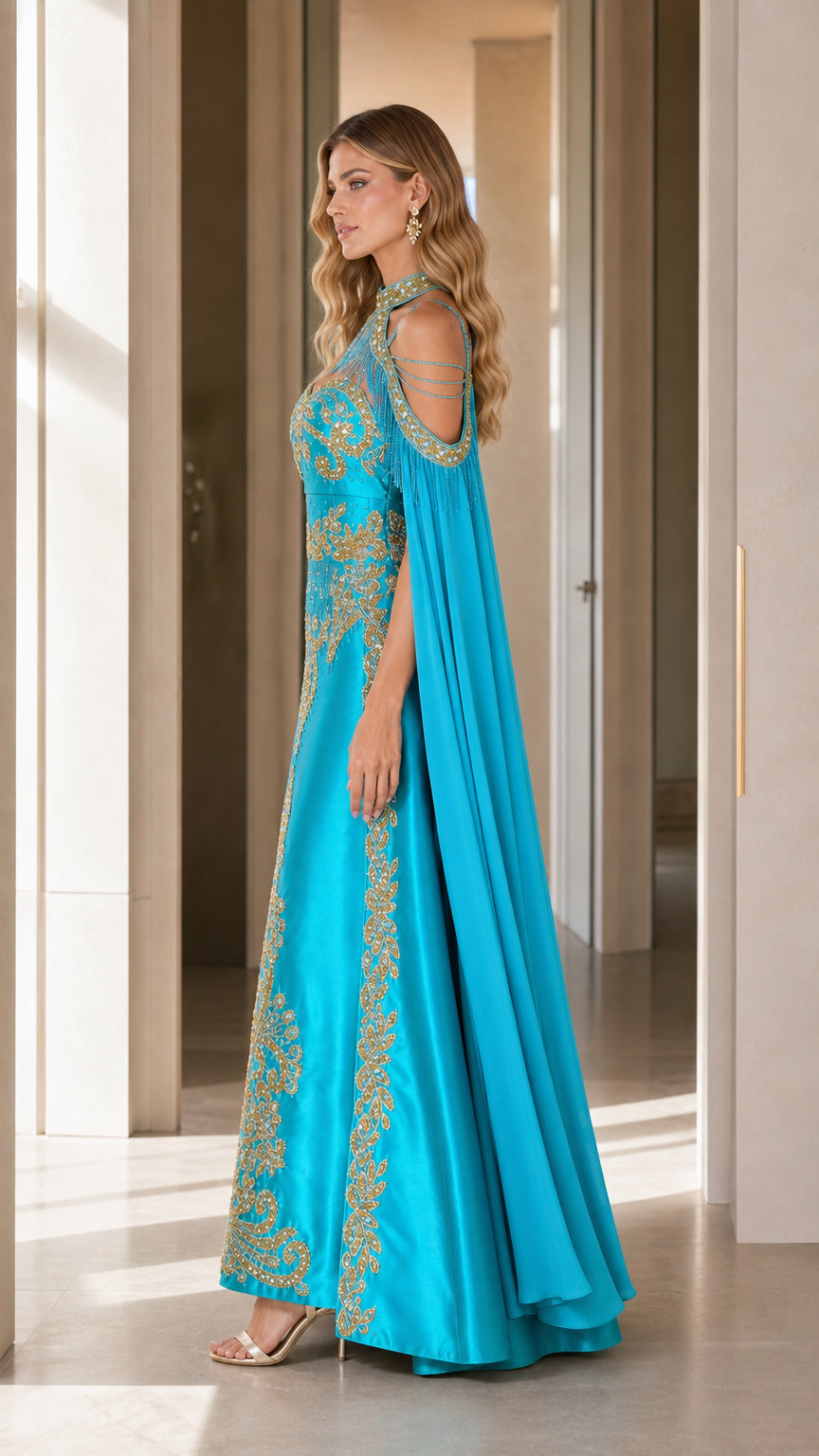 Side profile view of aqua blue embroidered formal dress showing cape drape