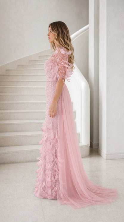 Side profile of blush pink formal dress showing fitted silhouette and tulle train