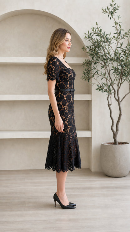 Side profile view of model wearing black floral lace mermaid midi dress