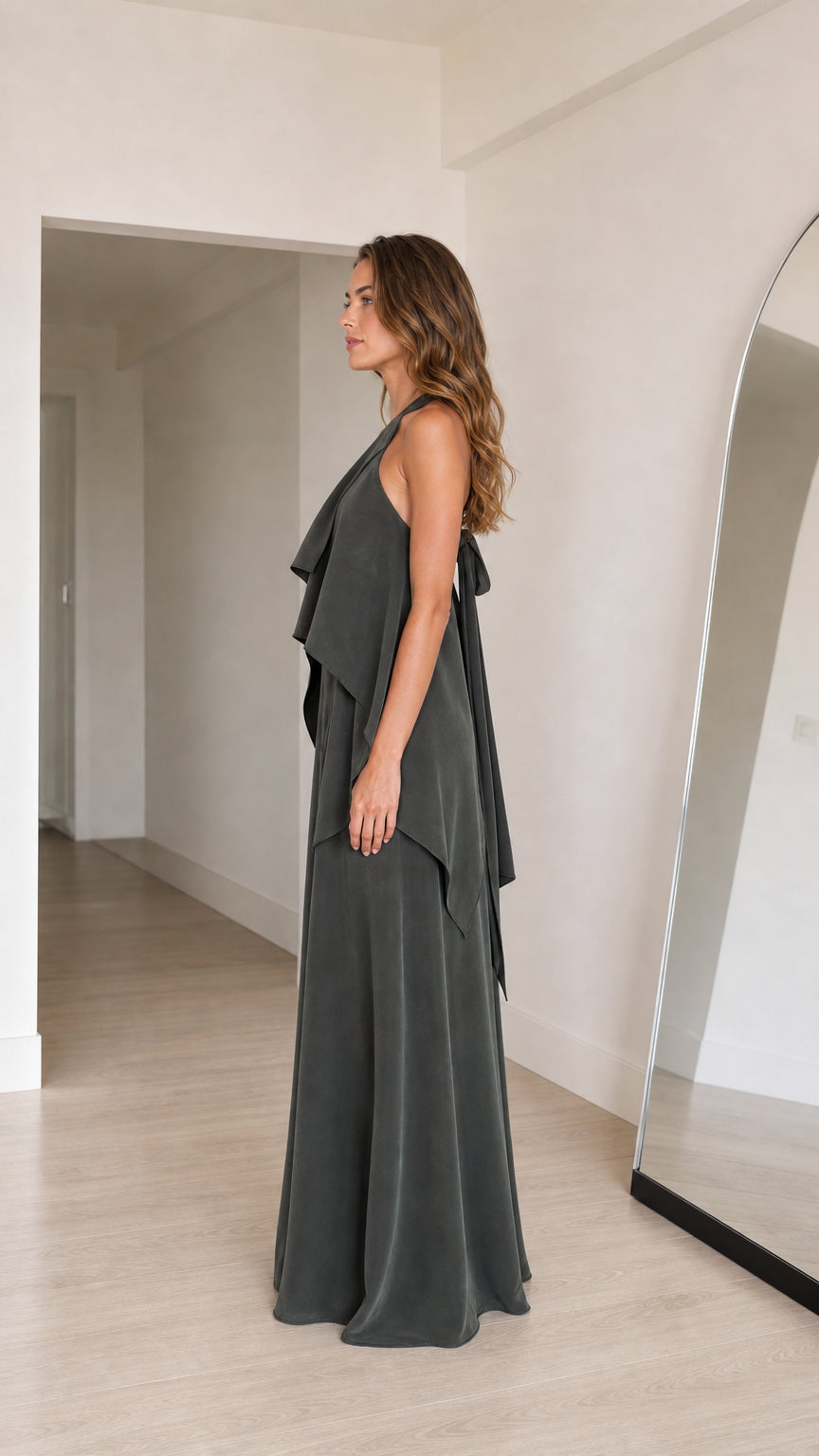 Side view of charcoal grey one-shoulder evening gown showing tiered ruffle details