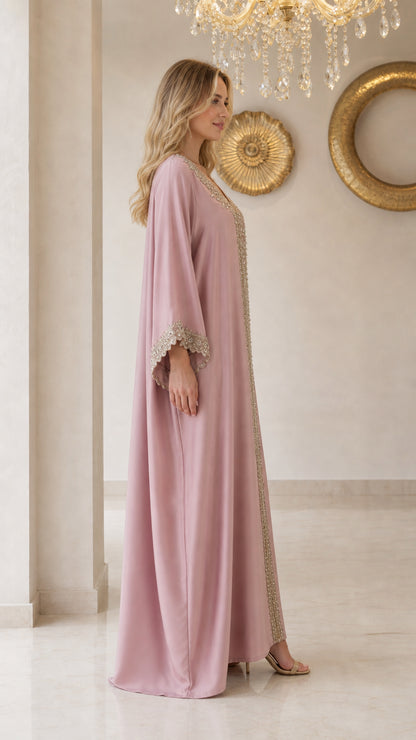 Side view of model wearing flowing dusty pink kaftan maxi dress
