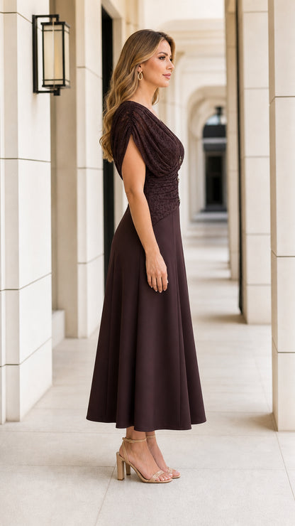 Side profile of model wearing chocolate brown ruched midi dress with draped sleeves