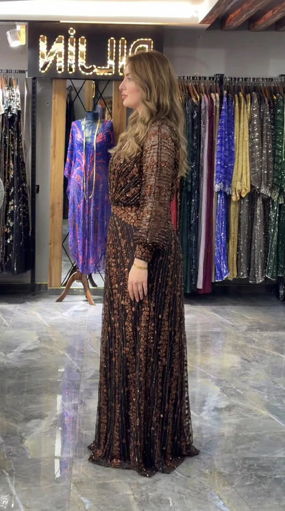 Side view of bronze black formal sequined evening gown showing sleeve and skirt drape